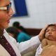 A doctor at Oswaldo Cruz Hospital examines a two-month-old baby with microcephaly on January 26, 2016 in Recife, Brazil. Credit: Getty.